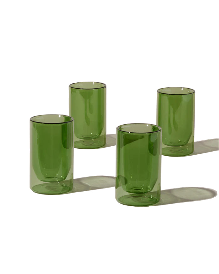 These double-wall glasses provide insulation suitable for use with hot or cold drinks. Double-wall glass insulates for a cool to touch experience without the need for a handle. The form visually suspends liquid in the center, putting your coffee, tea, cocktails or water on elegant display. Borosilicate Glass. 12oz.