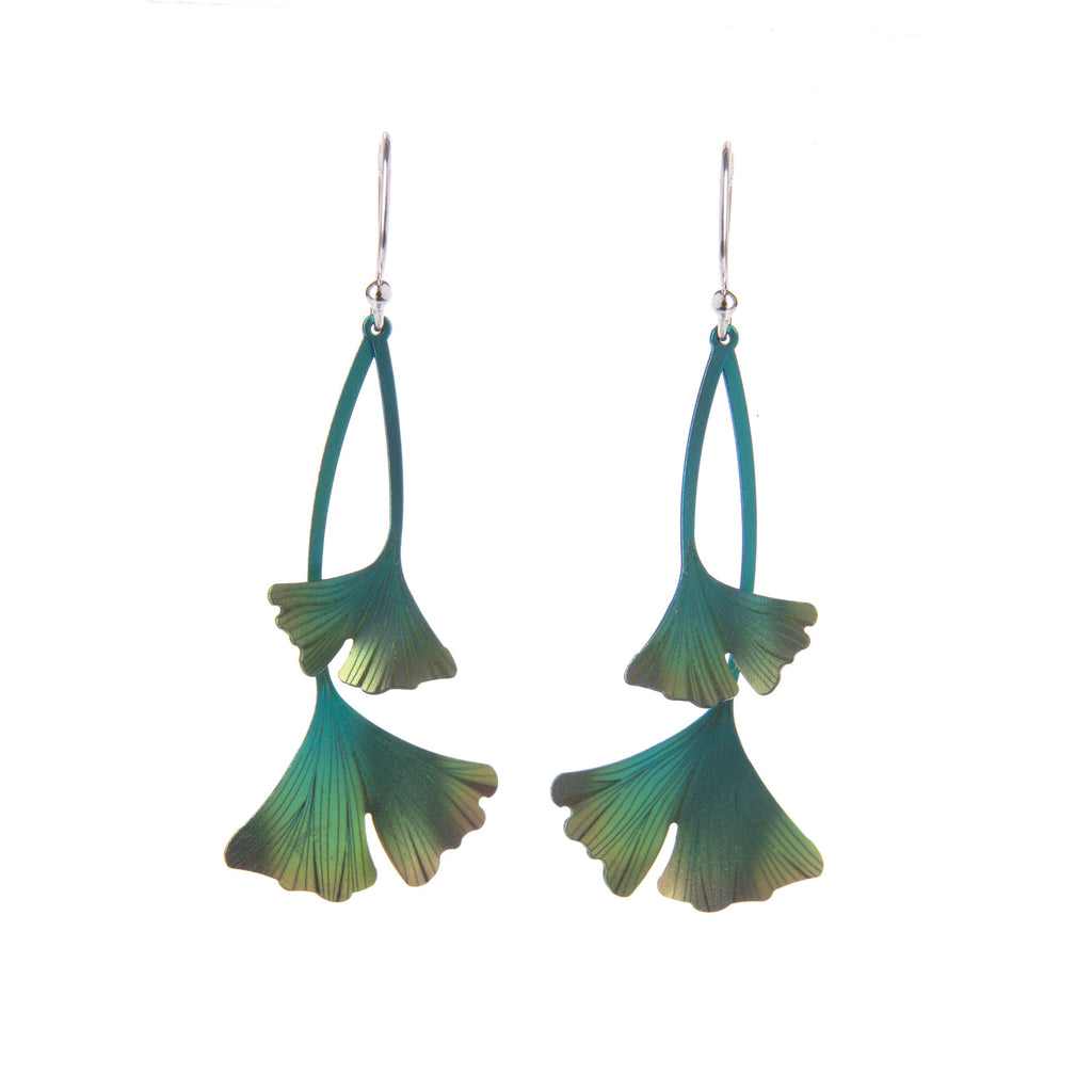 The distinctive fan-shaped leaves of the Ginkgo tree are beautifully recreated in these striking earrings. Made from laser-cut featherlight niobium, these earrings are delicately detailed and are finished with a three-tone green iridescent sheen. Niobium Sterling silver ear wires. Dimensions: 2 1/4" L. x 3/4" W.