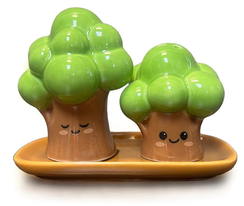 Add an adorable mini arboretum to your table setting with these tree-shaped salt and pepper shakers. Made from ceramic and finished with a shiny glaze, these happy trees sit on a matching plate to hold the pair in place. Material: ceramic Dimensions: 4.5” x 2” x 3.5” .Packaged in a gift-ready box.