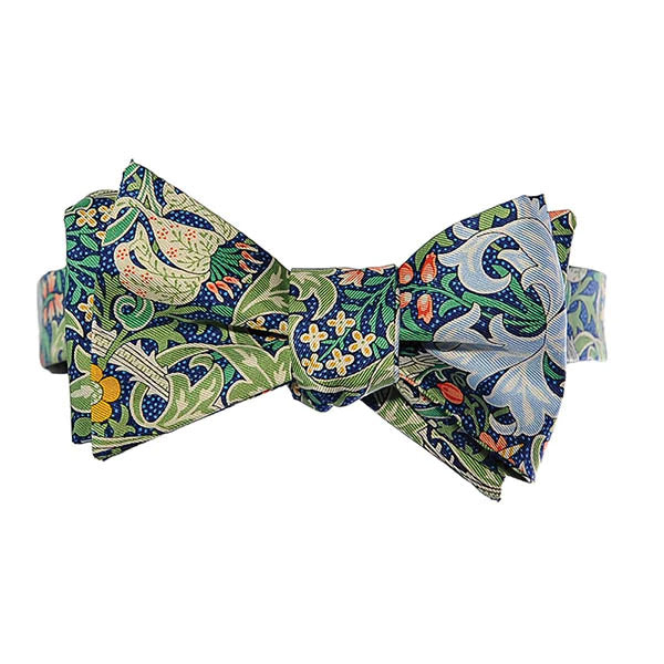 This delightfully dapper bow-tie features William Morris' Golden Lily print with a sapphire blue base. Made from pure silk and packaged in a giftable presentation box. Dry clean only. Includes simple 'how to tie a bow-tie' pictoral instructions. Packaged in a giftable presentation box.