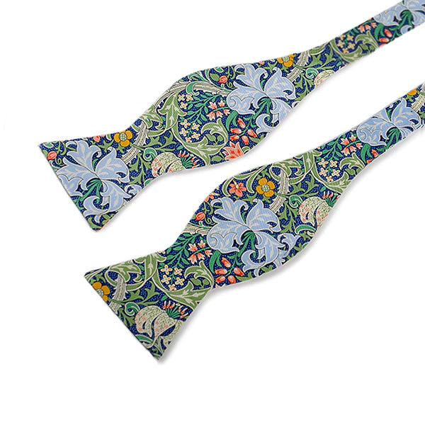 This delightfully dapper bow-tie features William Morris' Golden Lily print with a sapphire blue base. Made from pure silk and packaged in a giftable presentation box. Dry clean only. Includes simple 'how to tie a bow-tie' pictoral instructions. Packaged in a giftable presentation box.