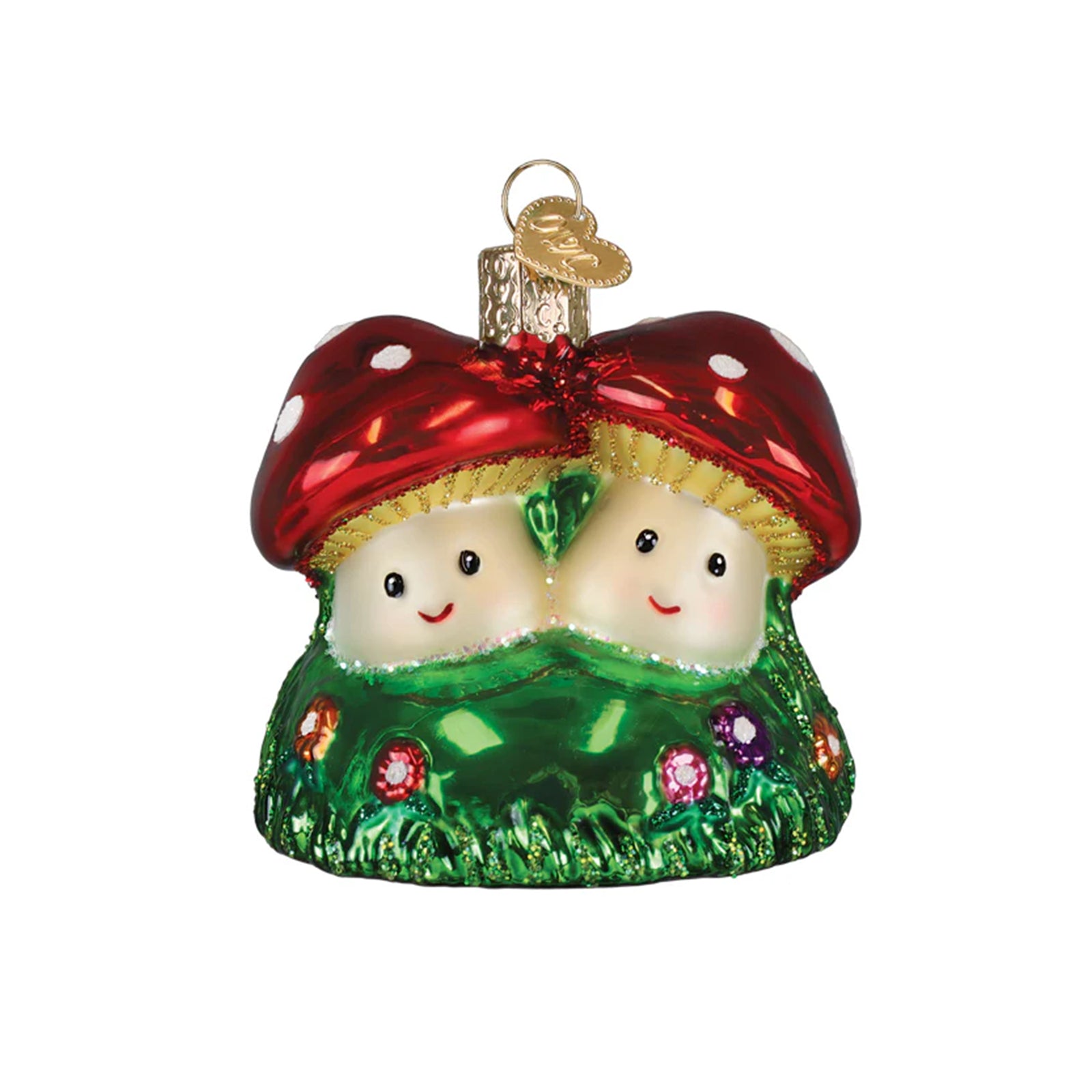 Decorative ornament of two smiling red mushrooms with green grass and flowers on a white background.