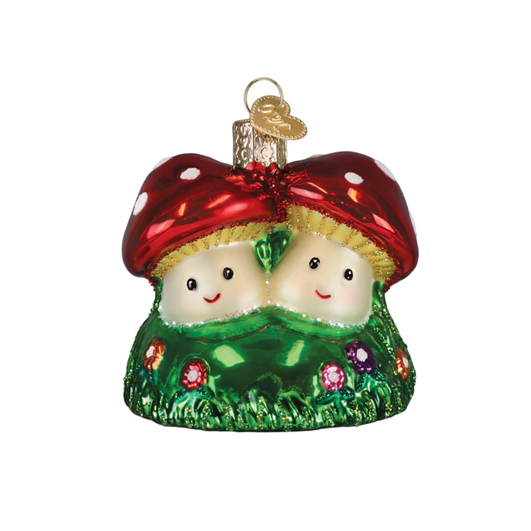 Decorative ornament of two smiling red mushrooms with green grass and flowers on a white background.