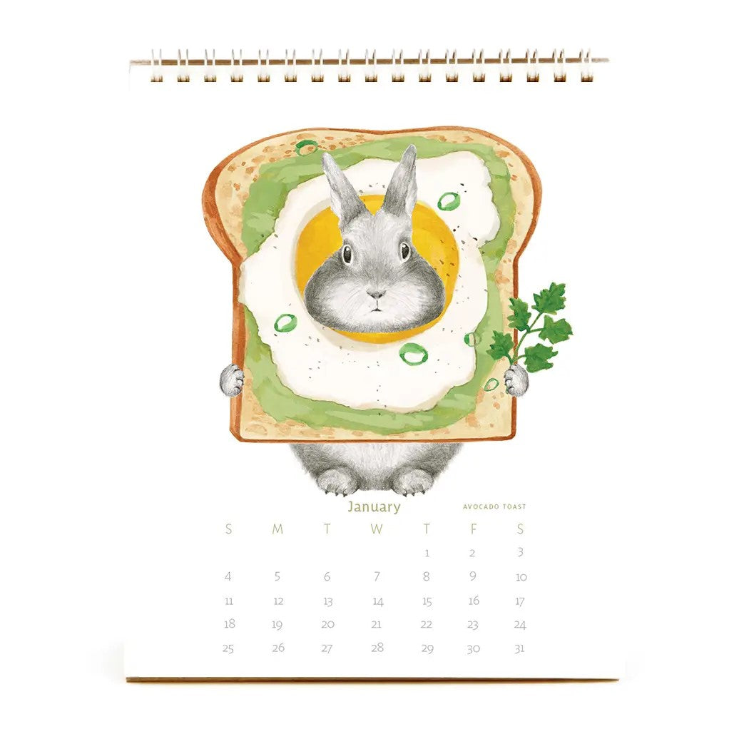 Calendar cover with a rabbit in a pink cup of coffee, titled 'The Bunny Calendar: Hare at the Cafe'.