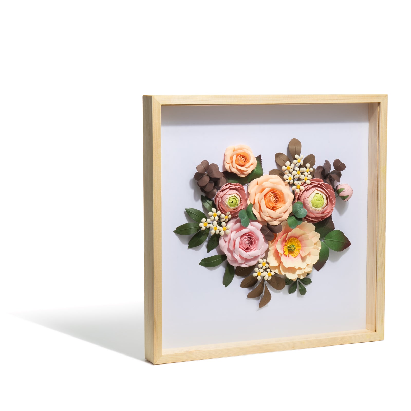 The gift of a beautiful floral bouquet brings joy and beauty into the home. This delightful shadow box art features a handcrafted paper flower bouquet that will brighten up any wall space. Handmade paper flowers mounted in a shadow box frame Materials: paper and glass with a solid pine frame. Dimensions: 15.7" x 15.7".