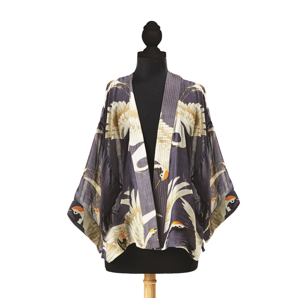 This stylish short kimono features an elegant vintage style Heron print on a charcoal grey background, which pairs easily with almost any color! This one-size, loose-fitting kimono style jacket has ¾ length sleeves, an open front and an embroidered lapel. One Size Fits Most (USA 6-16) 50% Modal, 59% Cupro. Hand wash.