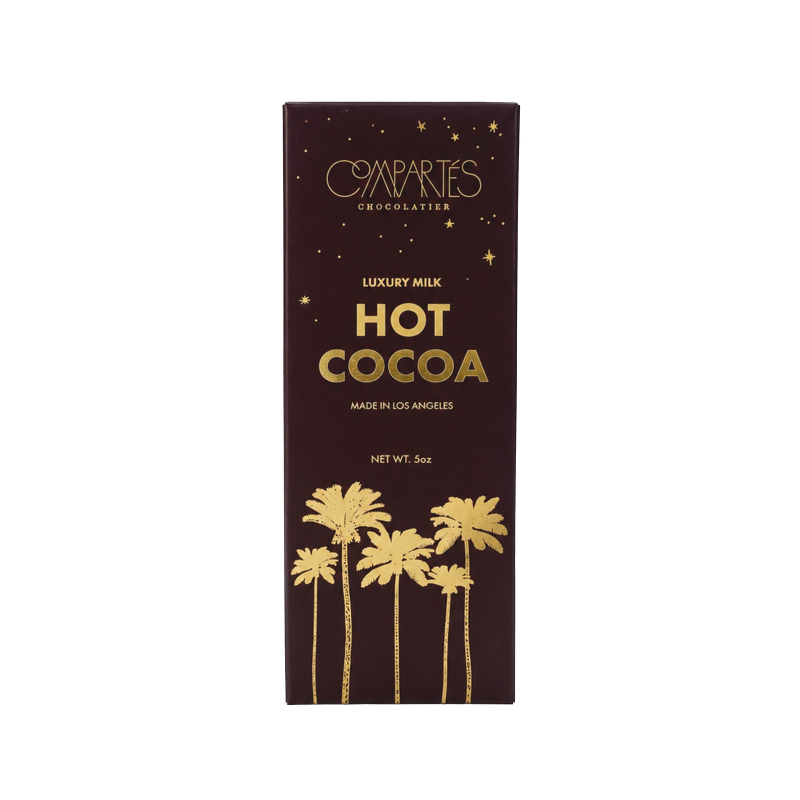 A box of luxury hot cocoa mix with a gold palm tree design on a dark brown box, on a white background.