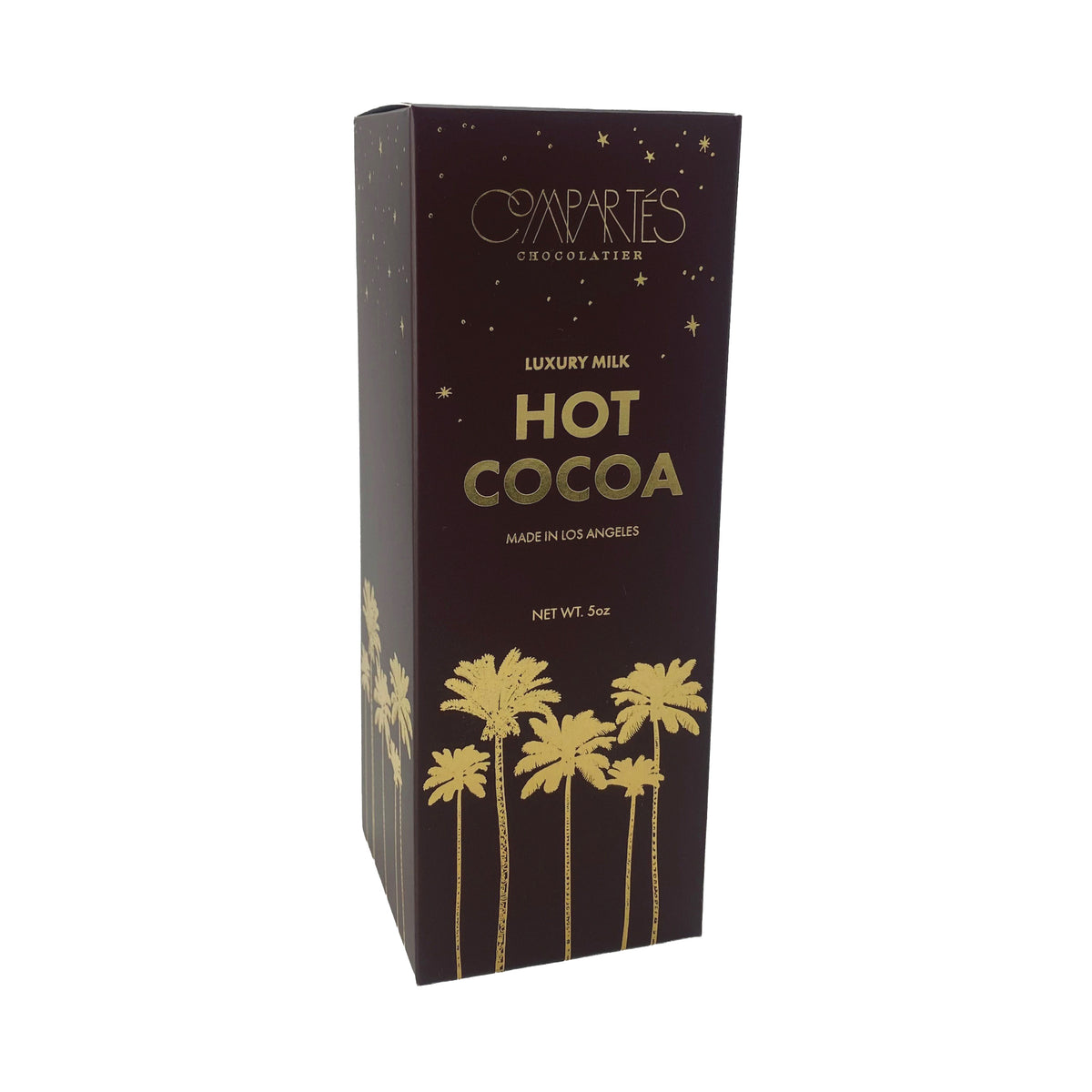 A box of luxury hot cocoa mix with a gold palm tree design on a dark brown box, on a white background.