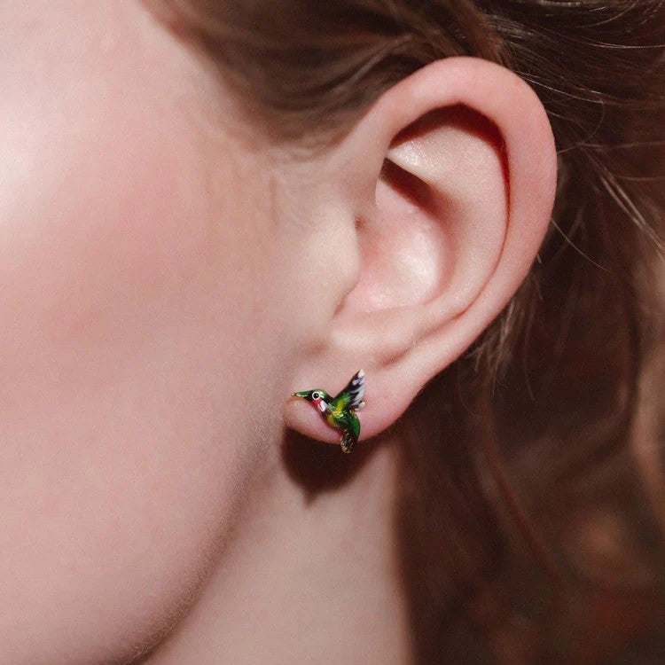 These colorful Hummingbird earrings are a stunning embodiment of life, love, and joy captured in delicate enamel detail. Crafted with meticulous attention, these earrings bring the graceful essence of the hummingbird to adorn your ears with elegance.