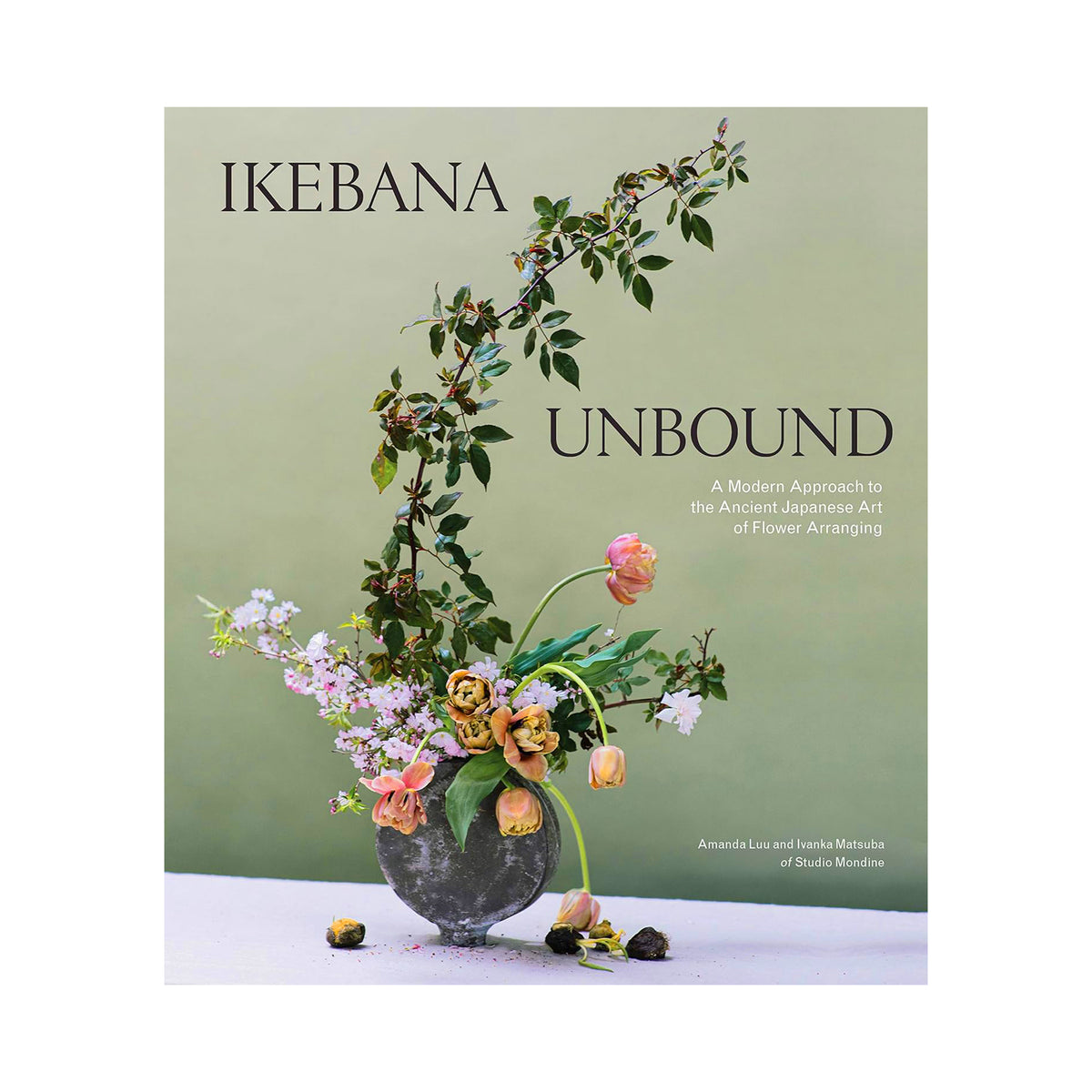 Book cover of 'Ikebana Unbound: A Modern Approach to the Ancient Japanese Art of Flower Arranging' featuring a floral arrangement in a dark stone vase against a muted sage green background.