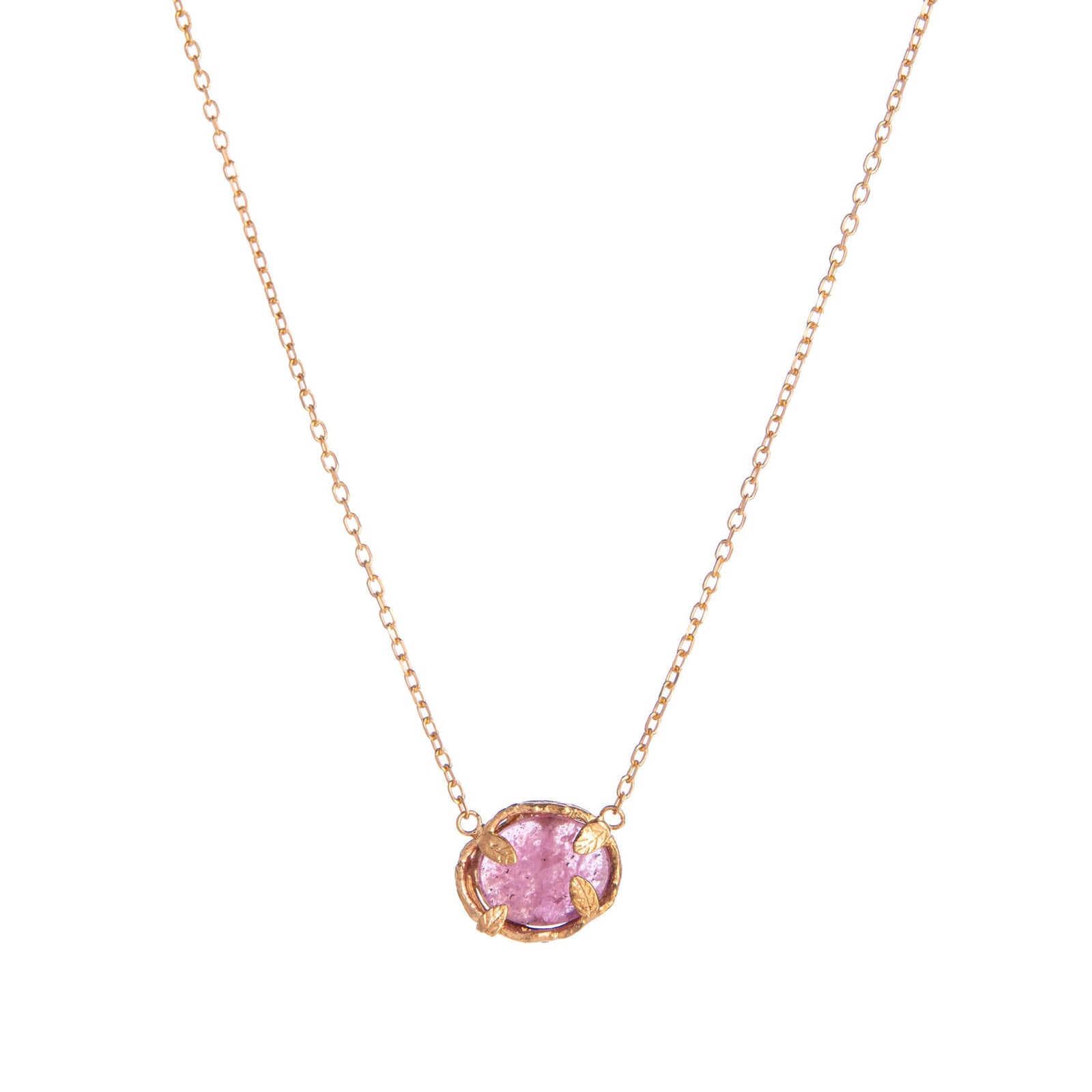 Gold necklace with a pink ruby gemstone pendant on a white background