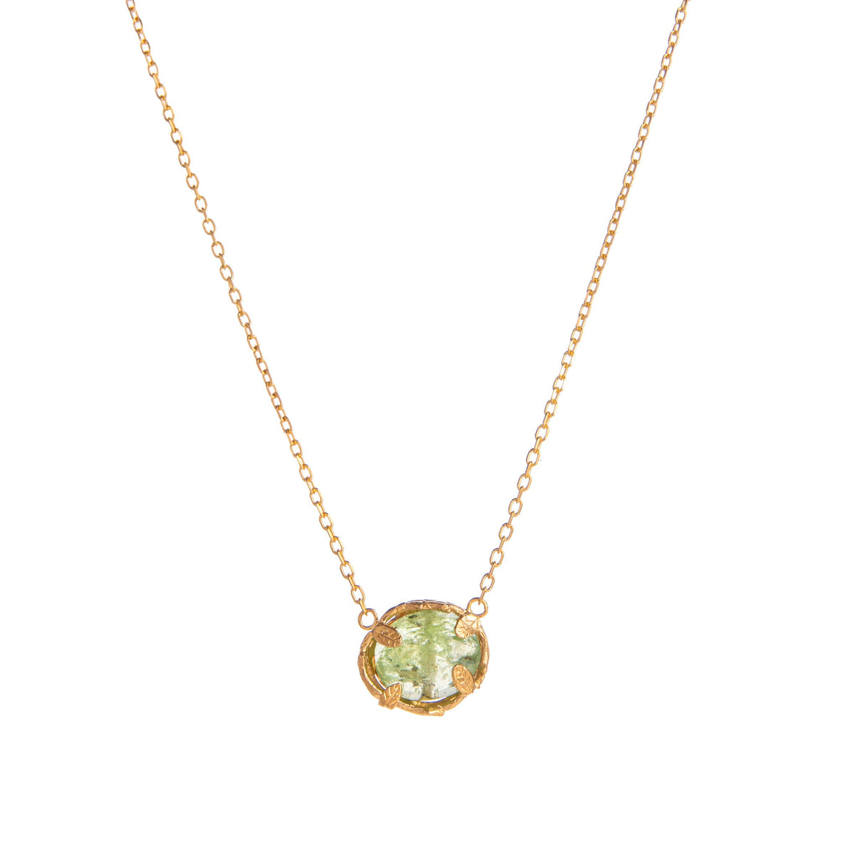 Gold necklace with a green kyanite gemstone pendant on a white background