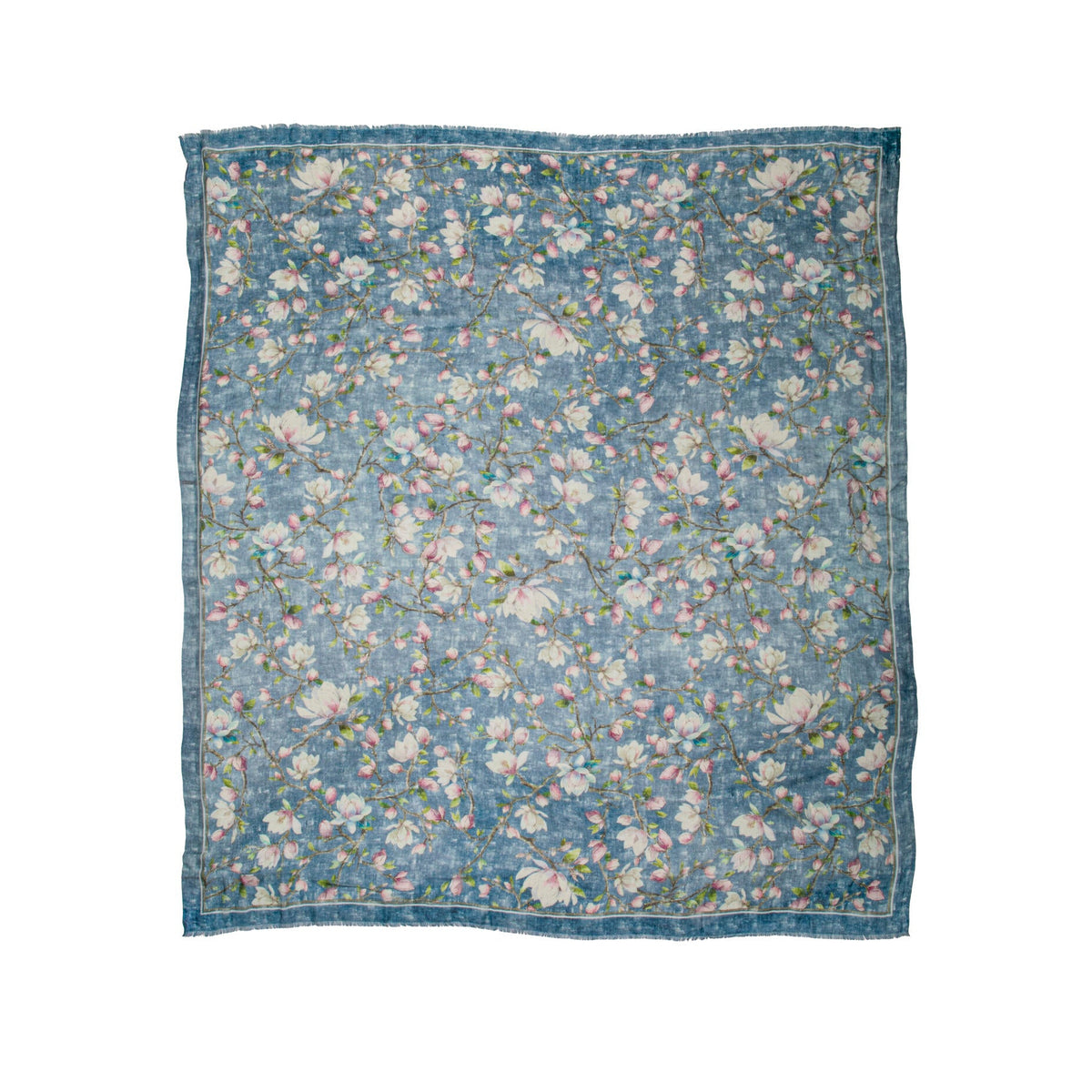 Floral patterned cashmere blend scarf with a magnolia floral print on an indigo blue base fabric on a white background
