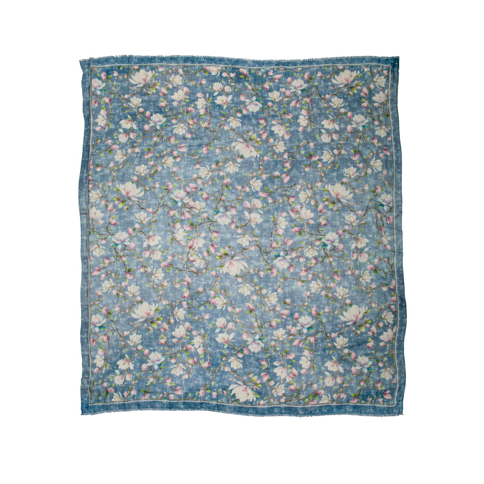 Floral patterned cashmere blend scarf with a magnolia floral print on an indigo blue base fabric on a white background