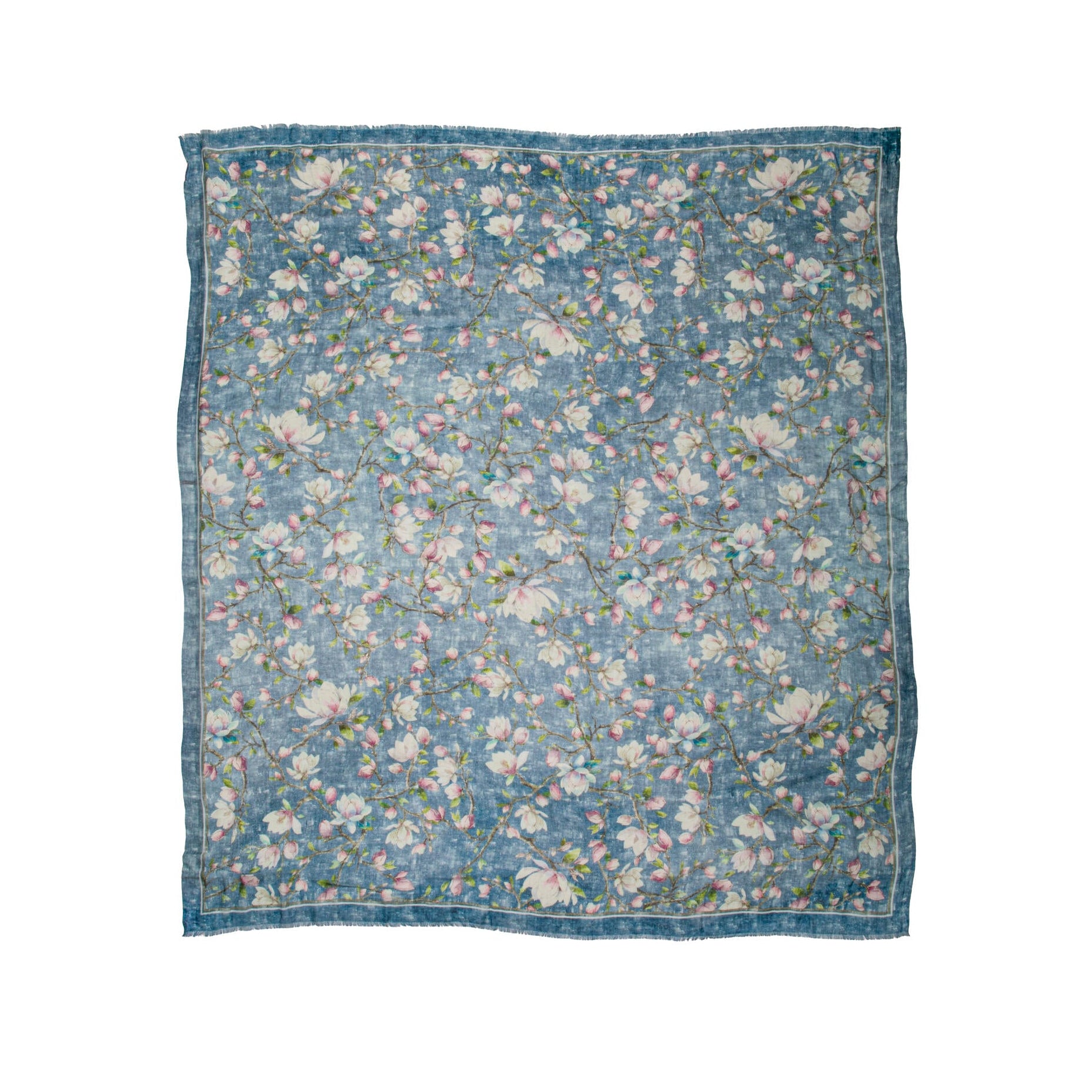 Floral patterned cashmere blend scarf with a magnolia floral print on an indigo blue base fabric on a white background