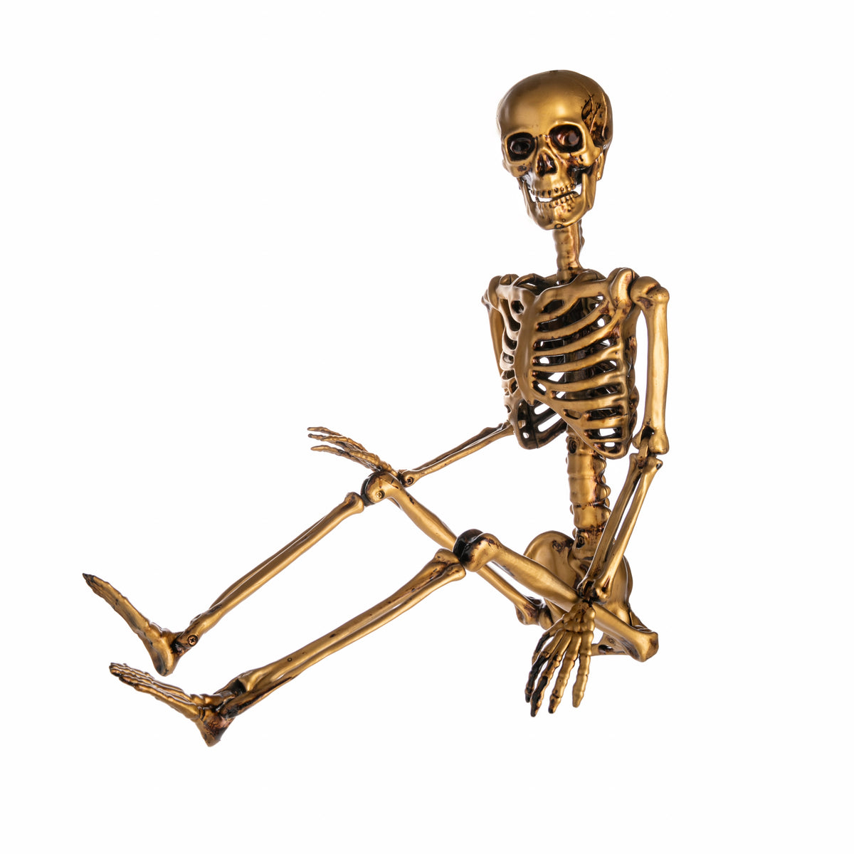 Gold skeleton figurine on a white background