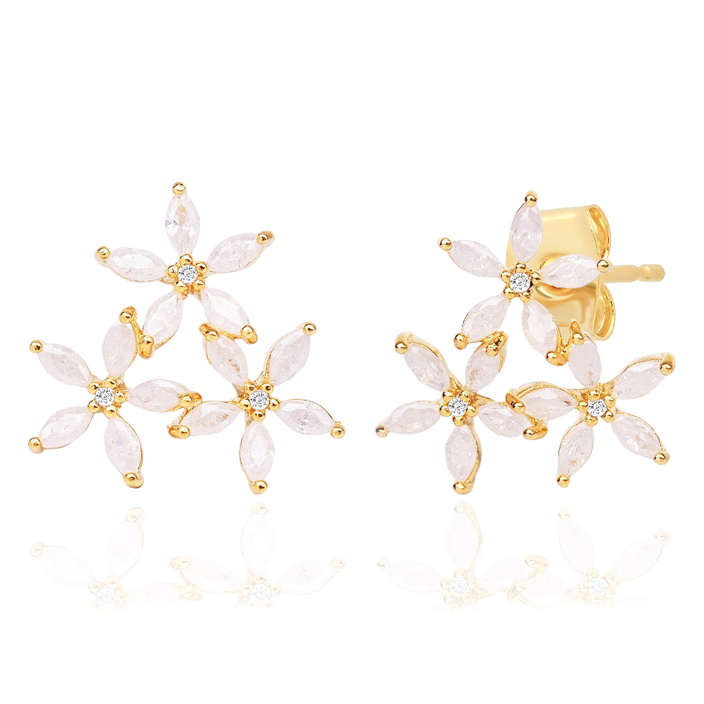 Gold and white floral earrings on a white background