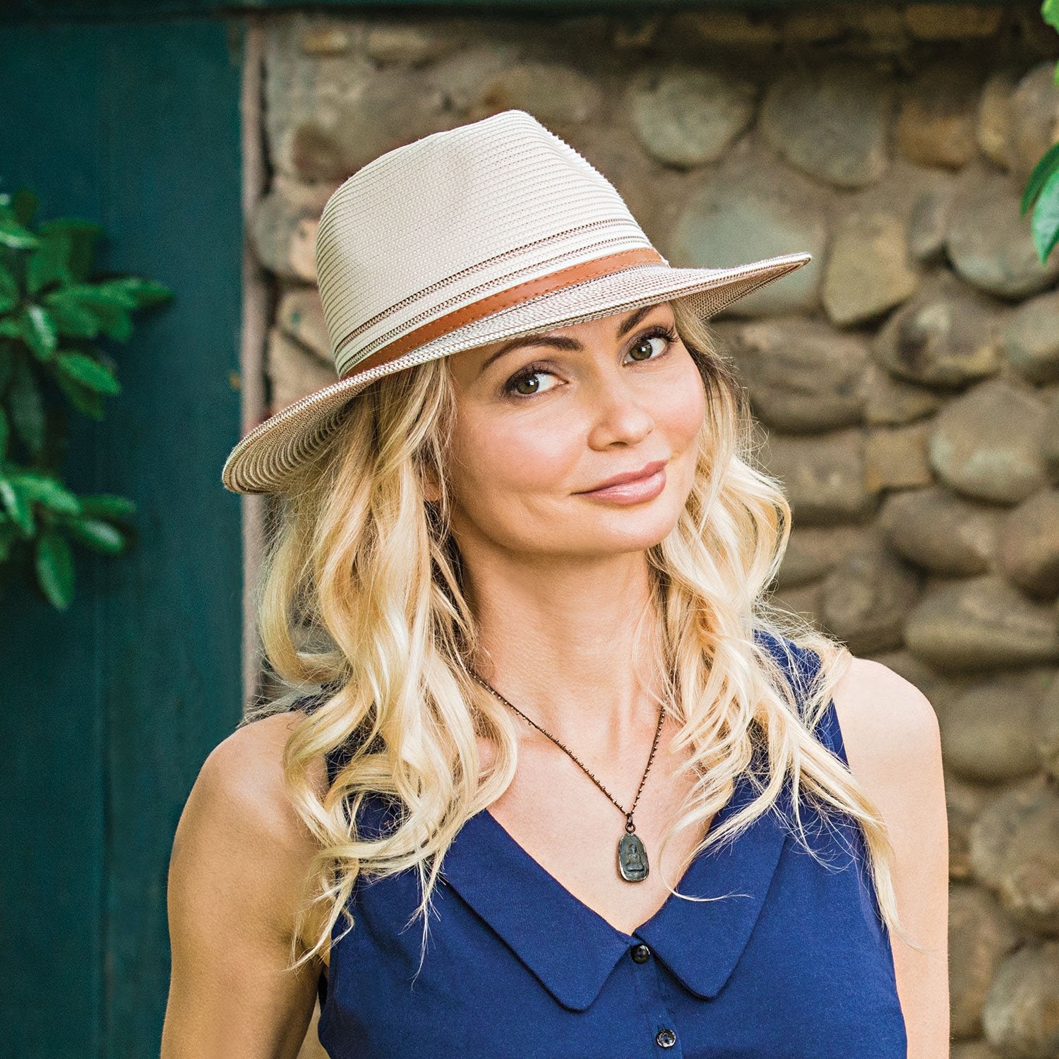 Classic design with a two-tone twist in this fedora style hat. This hat protects from the sun, while serving as a fun accessory to any outfit. Faux leather band. UPF 50+ fabric blocks 97.5% of ultraviolet rays. Packable Crown size: Medium - 22" Inner drawstring adjusts fit.