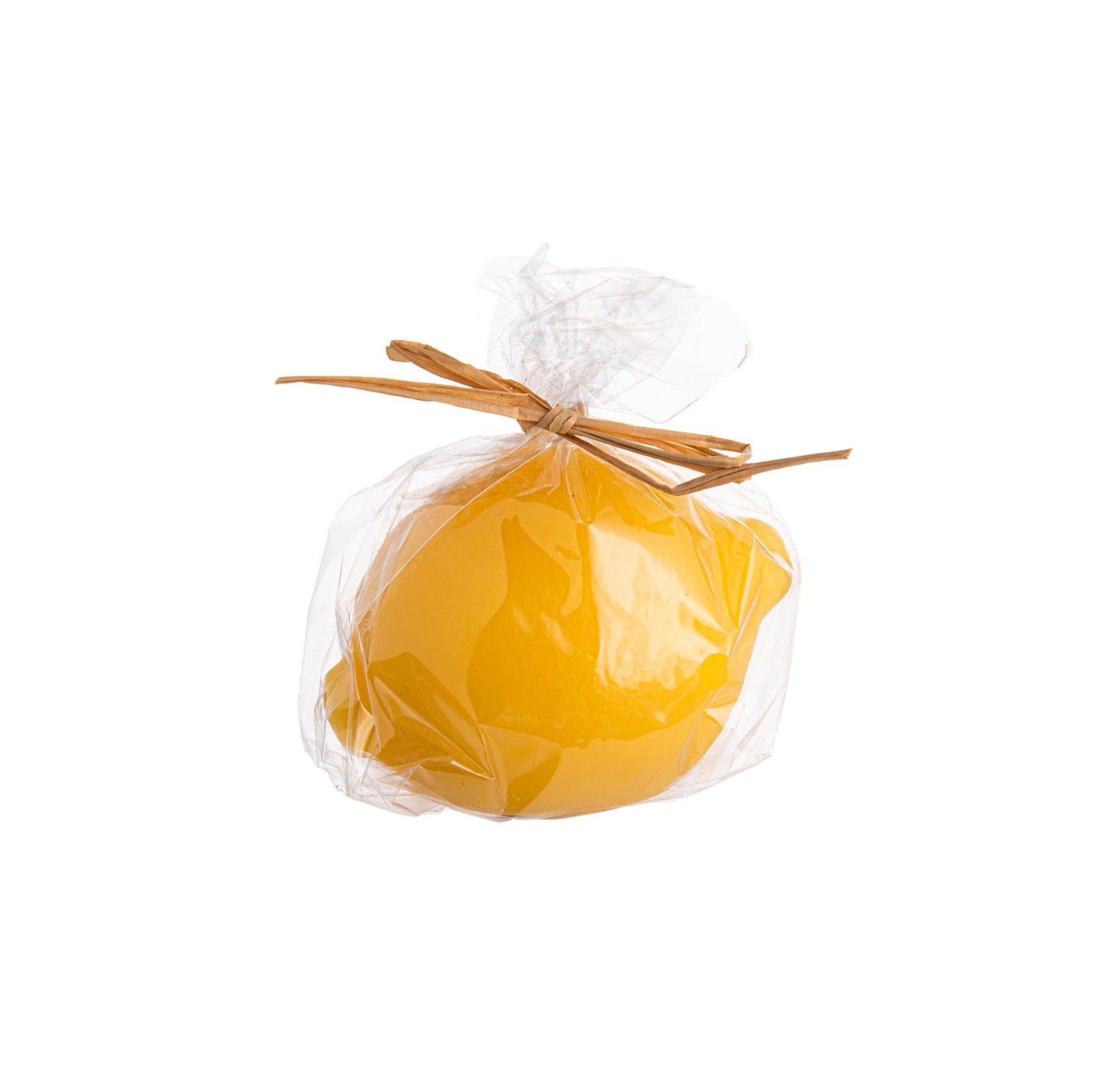 Yellow lemon-shaped candle on a white background