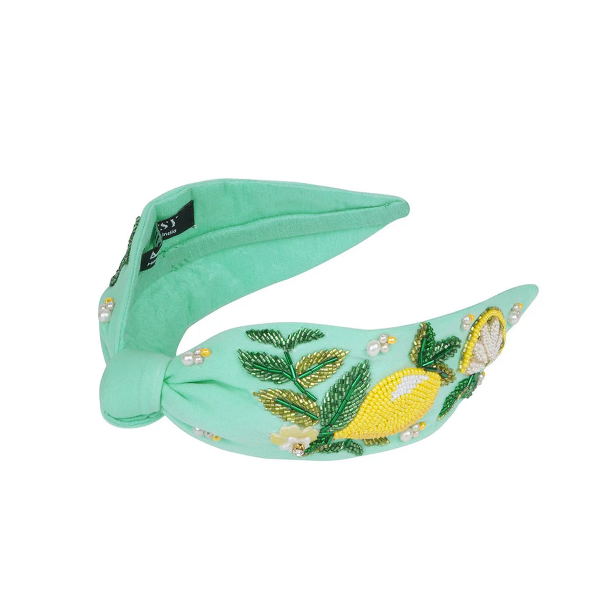 Mint green headband with embroidered lemons and leaves on a white background
