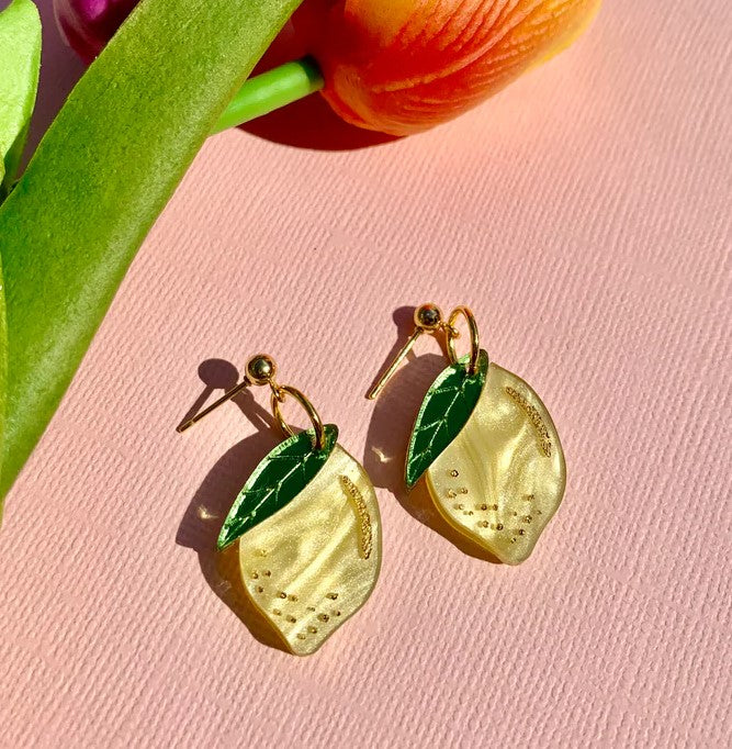 If life gives you these lovely lemon earrings, you're winning fashion-wise! These lightweight and fun earrings are made from laser-etched acrylic, with hand-painted details, giving them a three-dimensional effect. The studs are made from 18k gold plated stainless steel, making them safe and comfortable to wear. Materials: Acrylic, stainless steel, 18k gold plated Dimensions: 1" x 0.6"