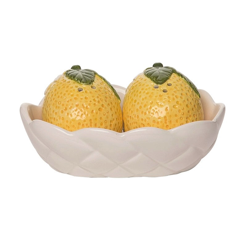 This zesty salt & pepper shaker set features two beautifully sculpted lemons, accented with flowers and set in a white lattice ceramic basket. This is the perfect set for adding a pretty, summery accent to your table setting, indoors or outdoors. Ceramic salt & pepper shaker set. Dimensions: 5" x 2.25" x 3".