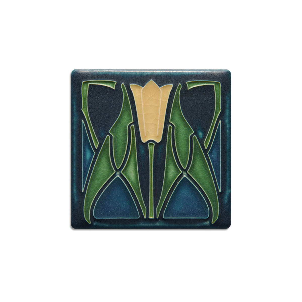 Decorative tile with a green floral design on a blue background