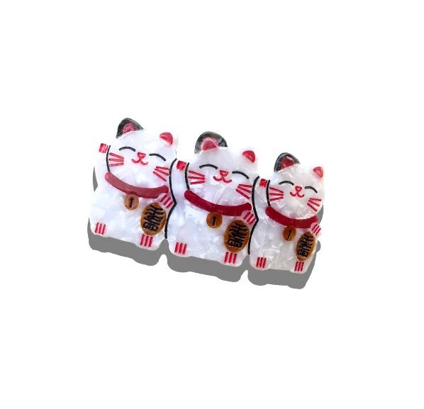 Add some extra luck to your hairdo with this triple-lucky cat barrette. This classic French-style barrette clip is finished with hand-painted details and crafted in small batches. It is perfect for both shorter and longer hairstyles. Material: Cellulose Acetate-crafted from an eco-friendly, biodegradable material made from recycled wood pulp.