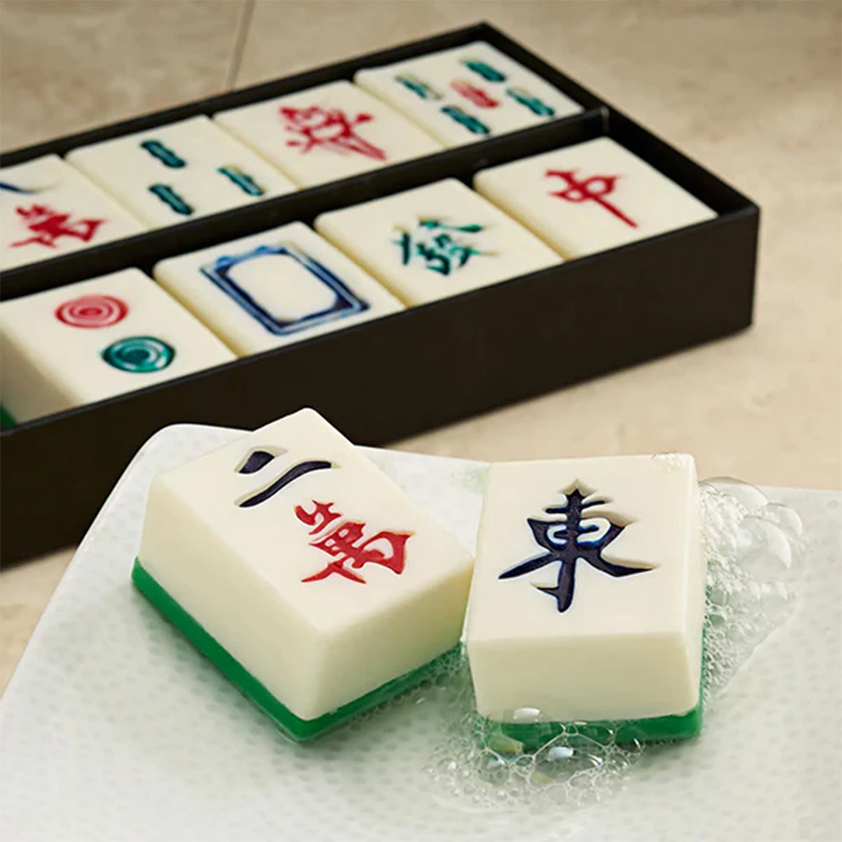 Close-up of soap set shaped like Mahjong tiles with a box in the background