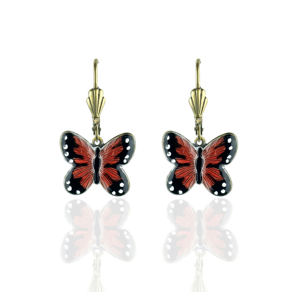 The widely recognized and majestic Monarch butterfly is represented in these earrings. With hand-enameled details, these realistic dangle earrings are a natural addition to any look. Nickel free antiqued brass findings. Surgical steel posts. Hand enameled details. Dimensions: 1/2″ L x 5/8″ W. Made in the USA.
