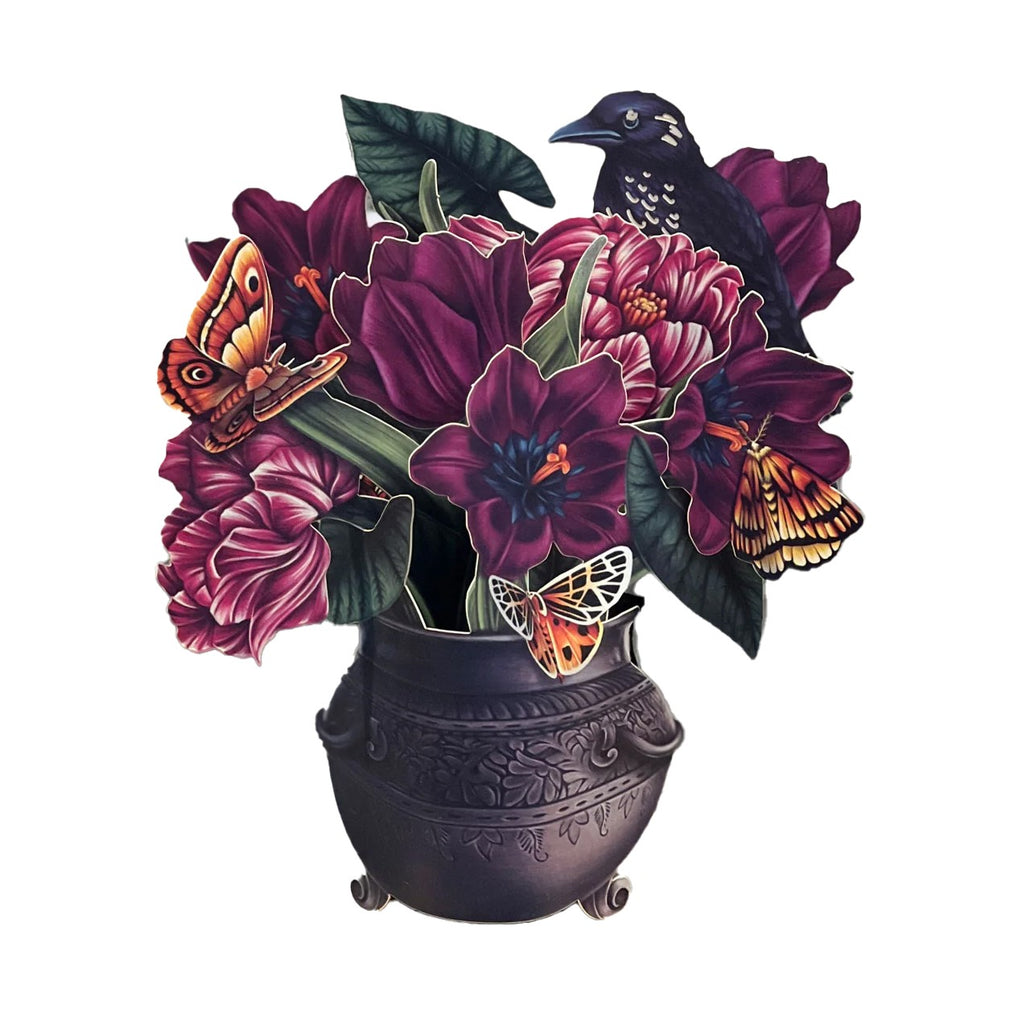 A small but spellbinding display of bewitching beauty enchants the home and office alike in this Moonlight Garden Bouquet pop-up greeting card. Displayed in a stunning pewter-colored cauldron, this mini bouquet of boo-tiful tulips and begonia leaves dazzle with velvety hues of deep purple and merlot. 5.5" x 5".