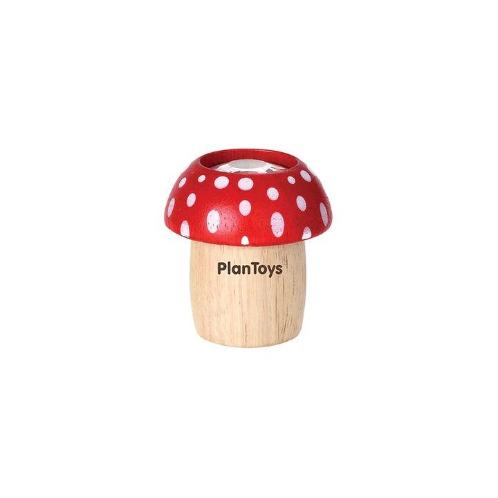 Wooden toy mushroom  kaleidoscope with red polka dot cap on a white background, branded 'PlanToys'.