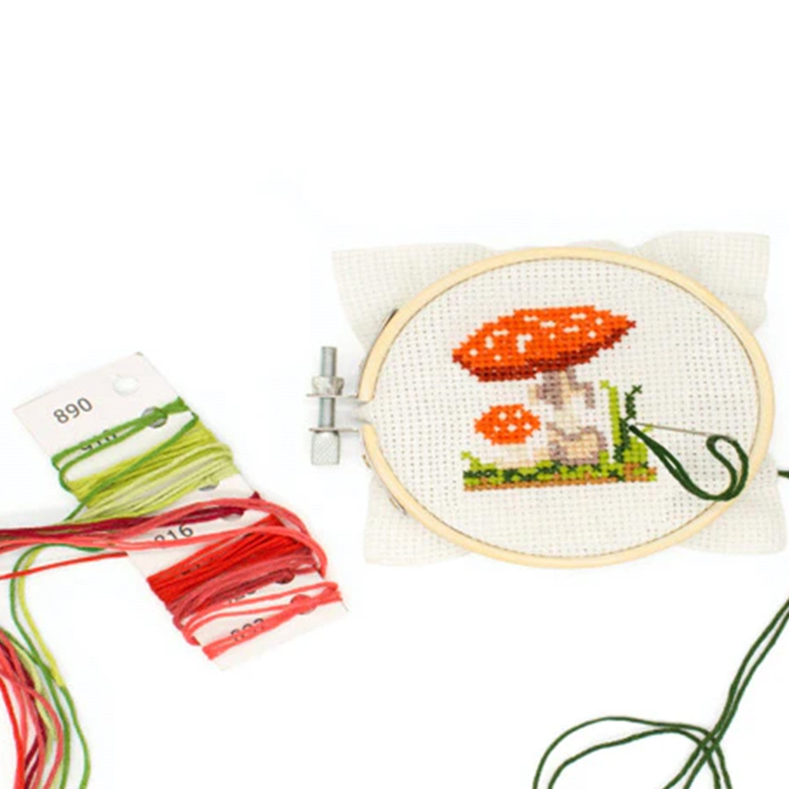 Embroidery kit packaging with mushroom design on a white background