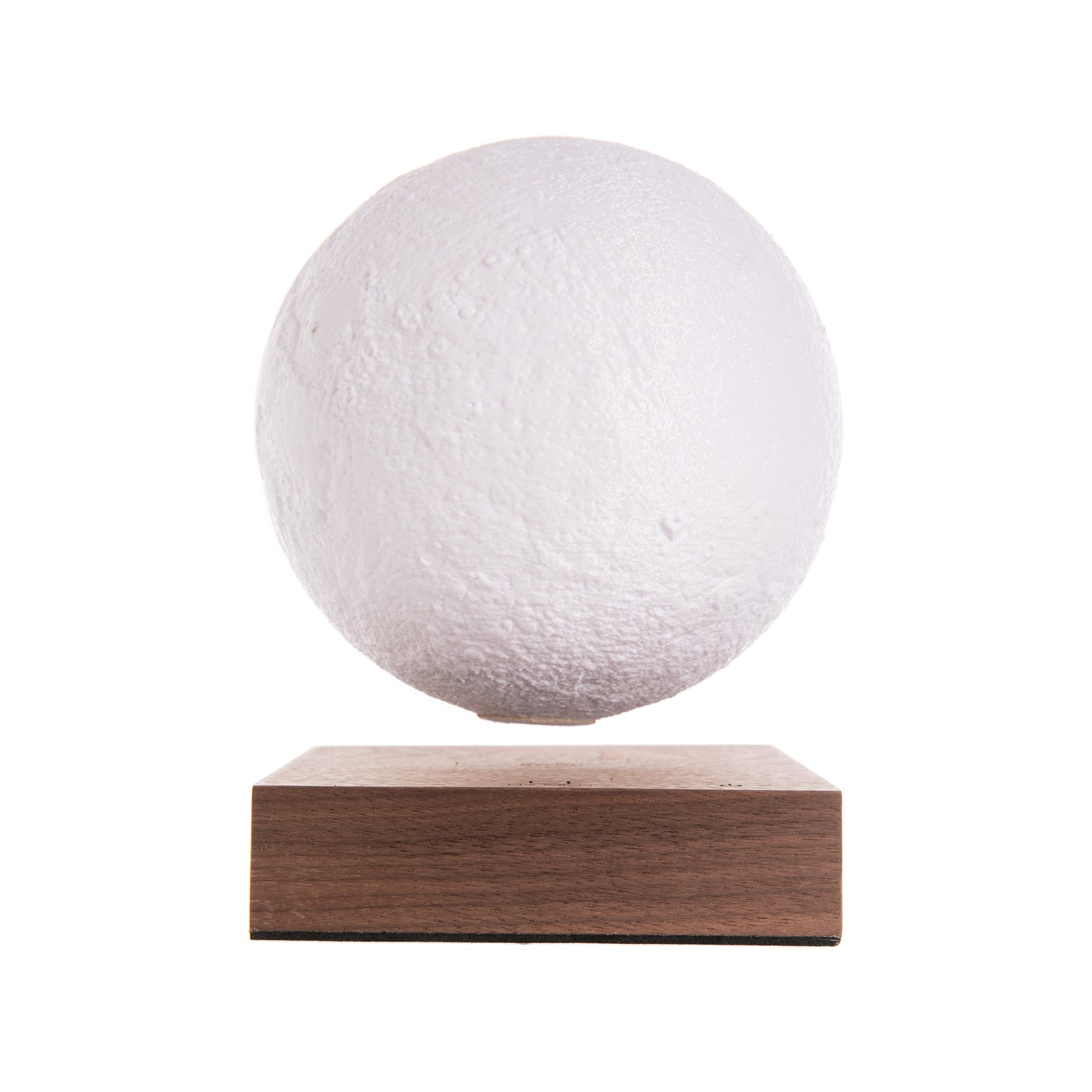 A rotating moon lamp with a textured surface, floating above a walnut wood base, illuminated in a warm white light.