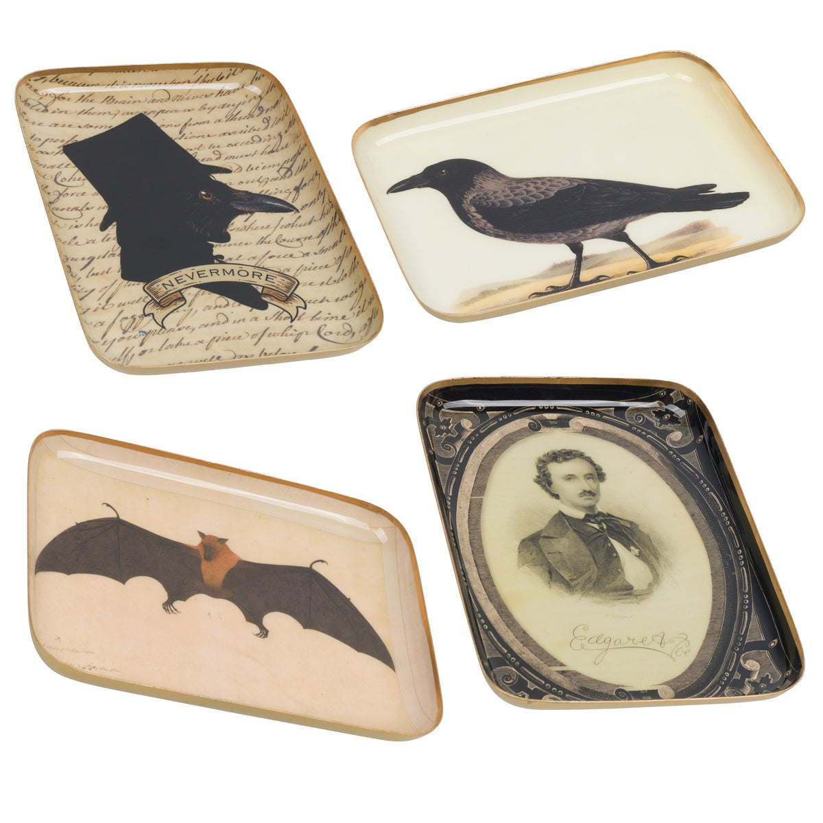 Four decorative rectangular trays with vintage-style illustrations on a white background. The designs include a black silhouette of a witch's hat over script with the word 'Clevermore,' a black bird, a bat with orange wings, and a sepia portrait in an oval frame.