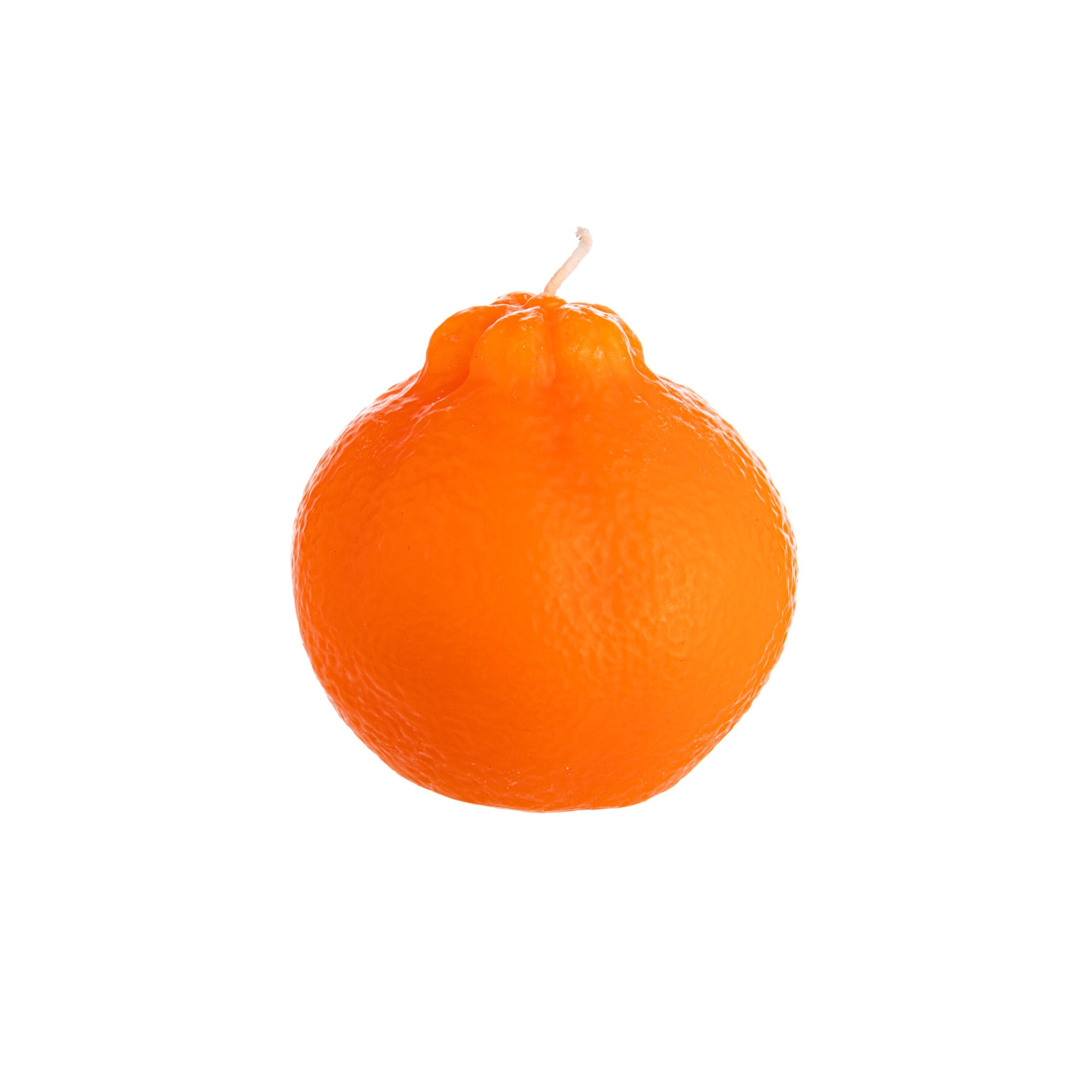 Orange-shaped candle with a wick on a white background