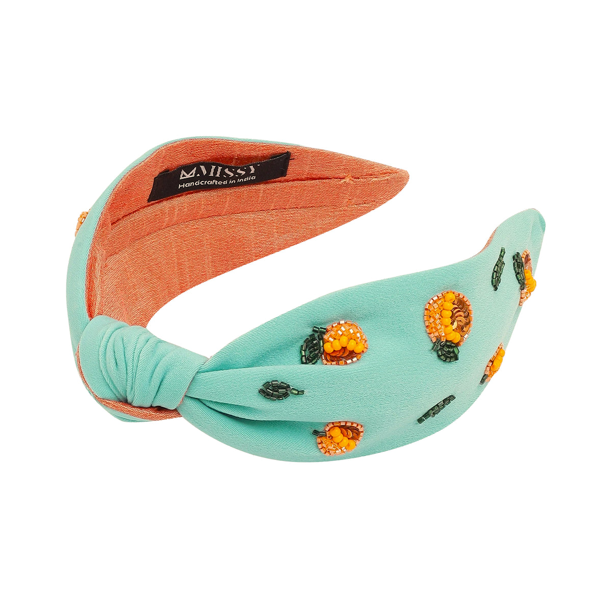 Turquoise and orange headband with floral embellishments on a white background