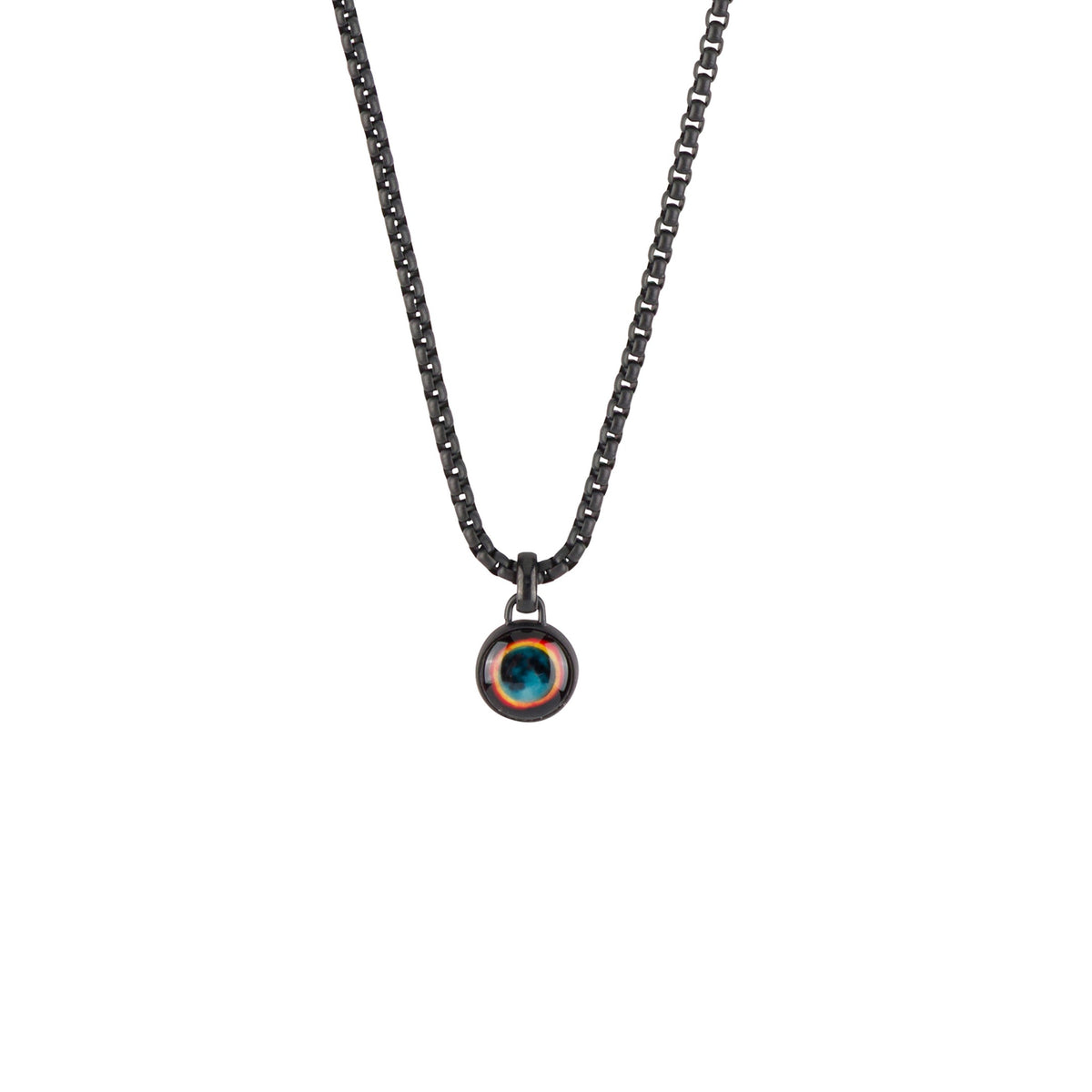 A dark gunmetal chain necklace with a small circular pendant featuring a colorful, textured inlay resembling a stylized eye or gemstone, shown against a plain white background.