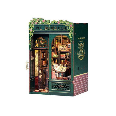 Model of a bookstore with 'Owl Bookstore' sign on a white background