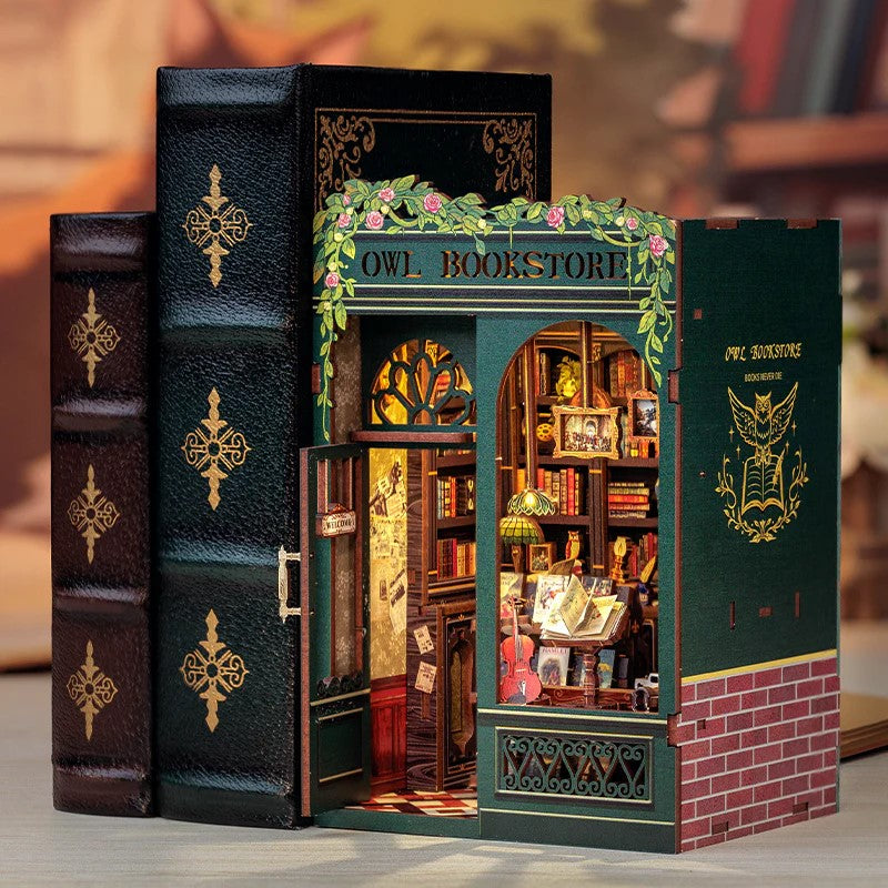 Model of a bookstore with 'Owl Bookstore' sign on a white background