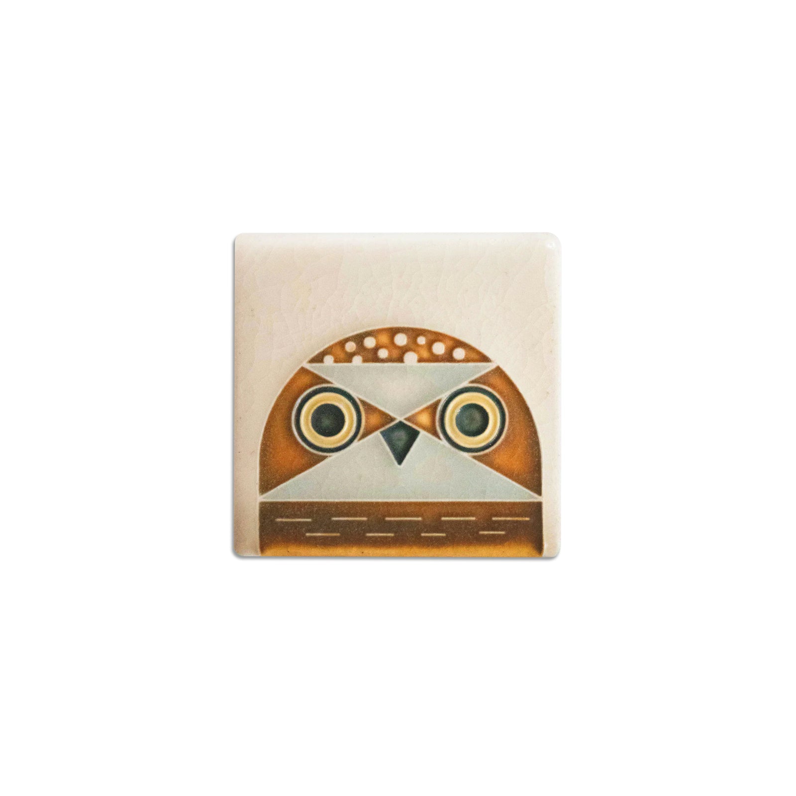Decorative tile with owl design on a beige background