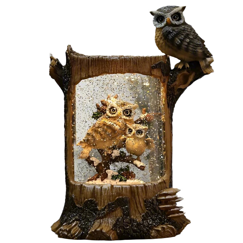 Discover the magic of nature with this lighted swirl log featuring a charming owl family scene. This 10" log-shaped snow globe brings a warm and inviting glow to any room, perfect for cozy evenings. Dimensions: 8.5" x 9.5" x 4" On/off switch with 8hr timer Can run from a USB cord or 3 AA BATTERIES (NOT INCLUDED).