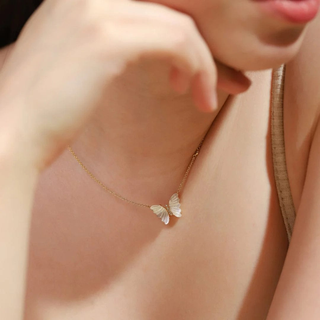 Beautifully elegant, this necklace features a butterfly, delicately carved from natural mother-of-pearl. The gold-plated brass chain is accented with a tiny crystal for a subtle and sophisticated touch of sparkle. Pendant is approximately 12mm in height and width, chain is 16 inches with a 2-inch extender.