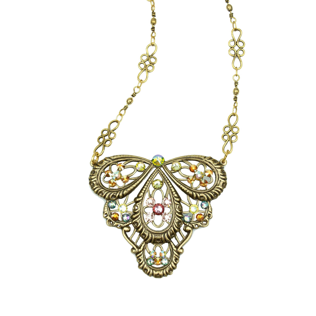 Emanate refined beauty in this antique inspired filigree necklace. Featuring a brilliant crystal accented and layered teardrop design, with coordinating chain, this exquisite necklace adds sophistication to any ensemble. Made in the USA. Dimensions: Centerpiece 1 5/8″ L x 1 3/4″ W; Chain 15-17 1/2″ adjustable.