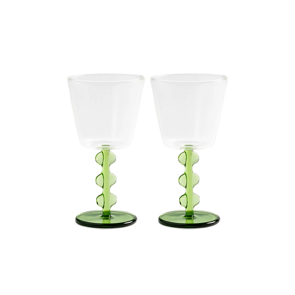Two clear glasses with green bases on a white background