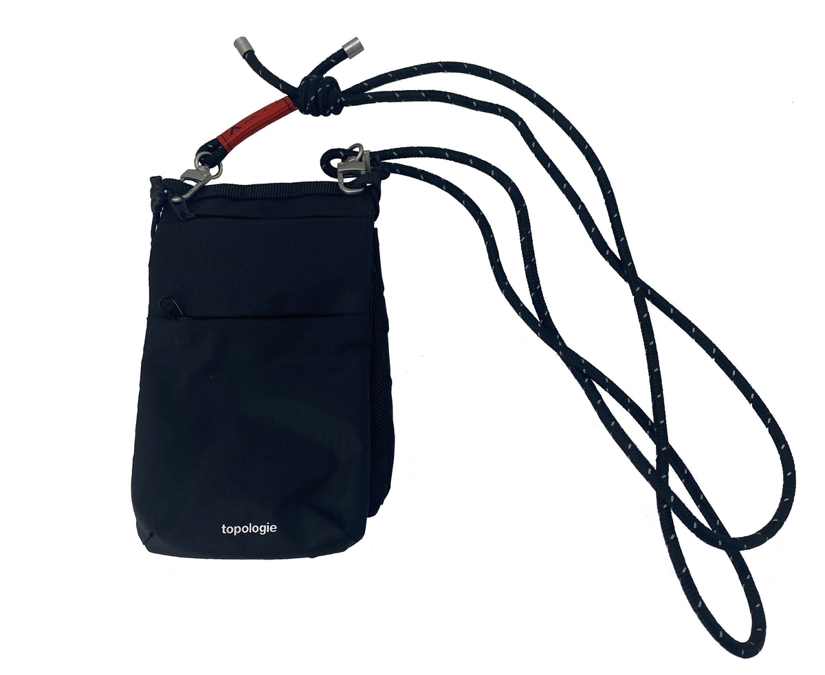The Phone Sacoche was created to carry all your everyday essentials within a compact design. With dedicated compartments for your phone, cards, cash, keys and versatile zipper pockets to hold your small items. The perfect, compact carry-all. Material: 1000D Polyester Dimensions: 11 x 19 x 2.5 cm