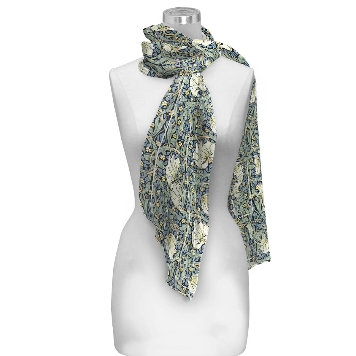 A lightweight scarf with a detailed floral and botanical William Morris 'Pimpernel' pattern in muted green, blue, and cream, draped on a white mannequin torso against a plain white background.