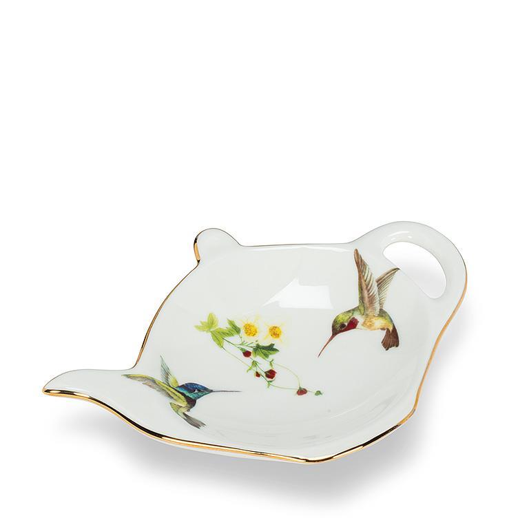 This delightful teabag holder is made from fine bone China and is adorned with a charming hummingbird motif. It is finished with luxurious 10K gold accents, making it a great way to add a touch of elegance to any tea party, or when serving coffee and desserts. Material: Fine bone China Dimensions: 2.5" x 2".