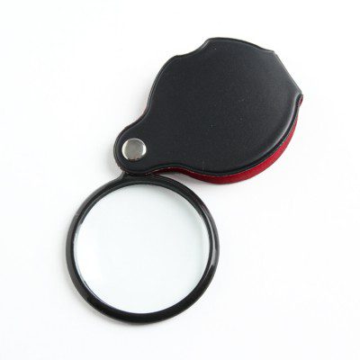 Black and red magnifying glass on a white background