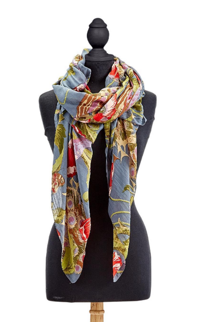 Elegant poppy flowers and colorful peacocks are detailed in this pattern over a blue-grey background. This scarf is made from a silk- like lightweight fabric blend. This Versatile Accessory Can be worn in a variety of beautiful ways, including as a shawl, waist wrap and scarf. Measures 40" W x 78" L. 